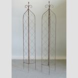 A pair of metal lattice garden spires,