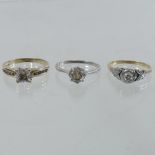 An unmarked diamond single stone ring, together with two others,