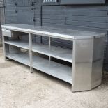 An industrial stainless steel work bench, containing a single drawer,