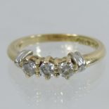 An 18 carat gold three stone diamond ring