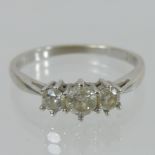An 18 carat white gold three stone diamond ring,