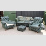A 1920's green leather button back suite, to include two arm chairs and a sofa,