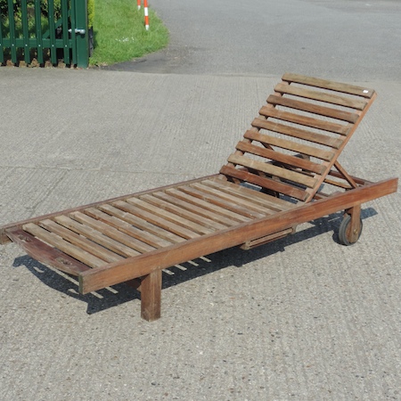 A teak slatted garden sun lounger