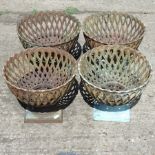 A set of four cast iron lattice planters,