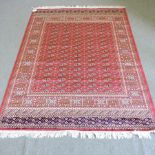 A Bokhara carpet, with all over designs, on a red ground,