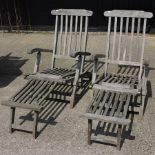 A pair of slatted teak steamer chairs