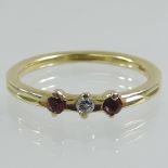 An 18 carat gold diamond and ruby three stone ring