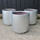 A set of three silver coloured garden planters,