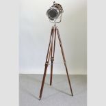A reproduction stage light on a tripod stand,