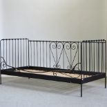 A black painted metal day bed, with a slatted wooden base,