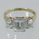 A large 9 carat gold three stone topaz ring,