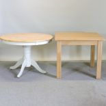 A white painted circular pedestal table together with a modern light oak table,