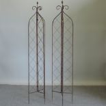 A pair of metal lattice garden spires,