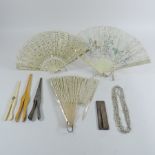 A 19th century ivory fan, boxed, together with various others, a pair of silver glove stretchers,