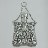 A silver scent bottle, relief decorated with scrolls,