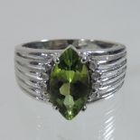 An 18 carat white gold and peridot ring,