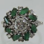 An 18 carat white gold emerald and diamond cluster ring, 0.