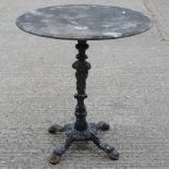 A Victorian cast iron table, with a marble top,