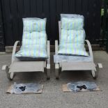 A pair of metal framed adjustable sun loungers,