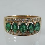 A five stone emerald and diamond three row ring,