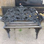A black painted cast iron ornate garden bench,
