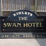 A large painted advertising sign for the Swan Hotel, together with another,