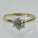 An 18 carat gold and diamond solitaire ring, 1.