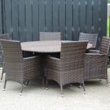 A circular rattan garden table, 150cm diameter,