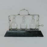 A silver plated three bottle tantalus, of small proportions,