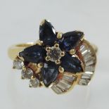 A yellow metal sapphire and diamond cluster ring,