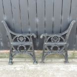 A pair of 19th century black painted cast iron bench ends