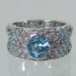 A Links of London 18 carat white gold topaz, diamond and sapphire dress ring,