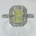 A large platinum and diamond ring, the yellow central stone 1.