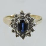 A 14 carat gold sapphire and diamond cluster ring,