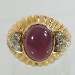 An 18 carat gold, cabochon ruby and diamond ring,