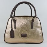 An Osprey gold coloured handbag,