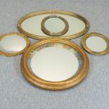 A collection of five various gilt framed wall mirrors,