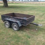 A wooden car trailer, with a double axle and tarpaulin cover,