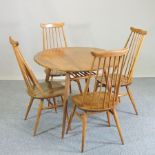 An Ercol light elm circular dining table, 98cm,