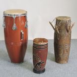 A collection of three African drums,