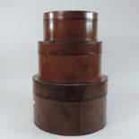 A graduated set of three leather hat boxes,