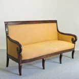 A 19th century French mahogany Empire style yellow upholstered show frame sofa,