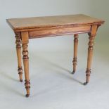 A Victorian oak folding rectangular folding card table, on turned legs,