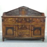 An 18th century oak sideboard, having a shaped gallery back,