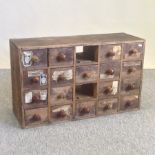 A 19th century pine apothecary chest, containing an arrangement of twenty small drawers,