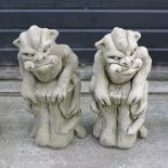 A pair of reconstituted stone models of gargoyles,