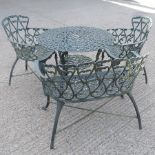 A green painted cast iron garden table, bench and two chairs,