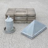 A galvanised feeder, together with a wooden chicken crate,