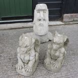 A reconstituted stone Easter Island head, together with a pair of grotesques,