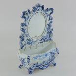 An early 19th century Dutch Delft blue and white mirror,